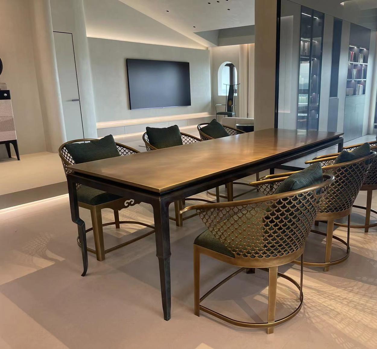 Aged brass dining table with perforated brass armchairs