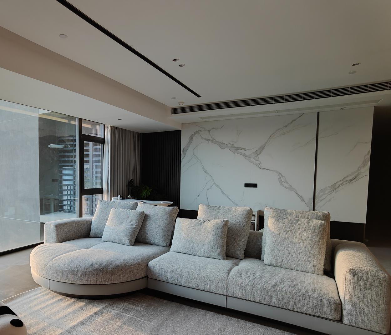 The sectional against a book-matched marble wall