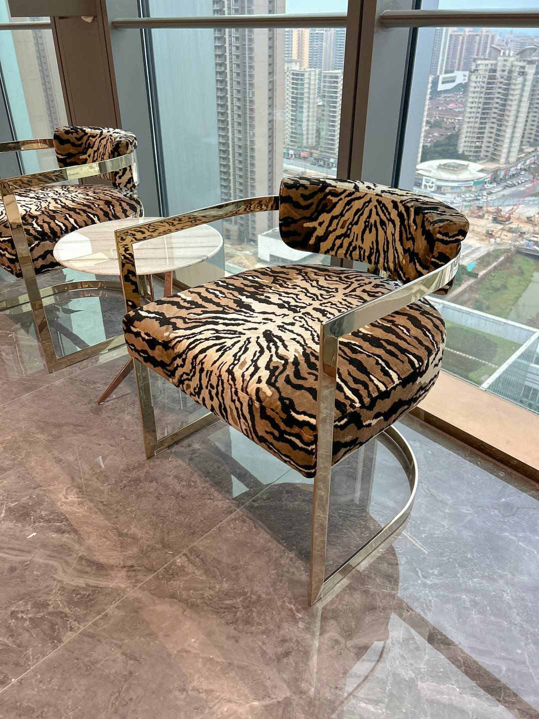 Tiger-velvet armchairs on slim steel frames