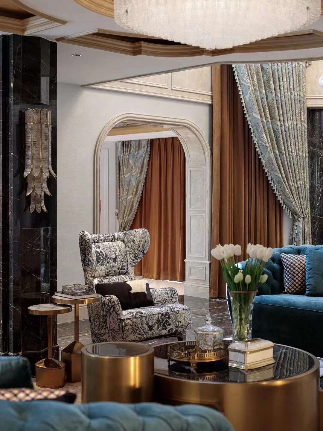 Wing chair in printed linen, beside the salon arch